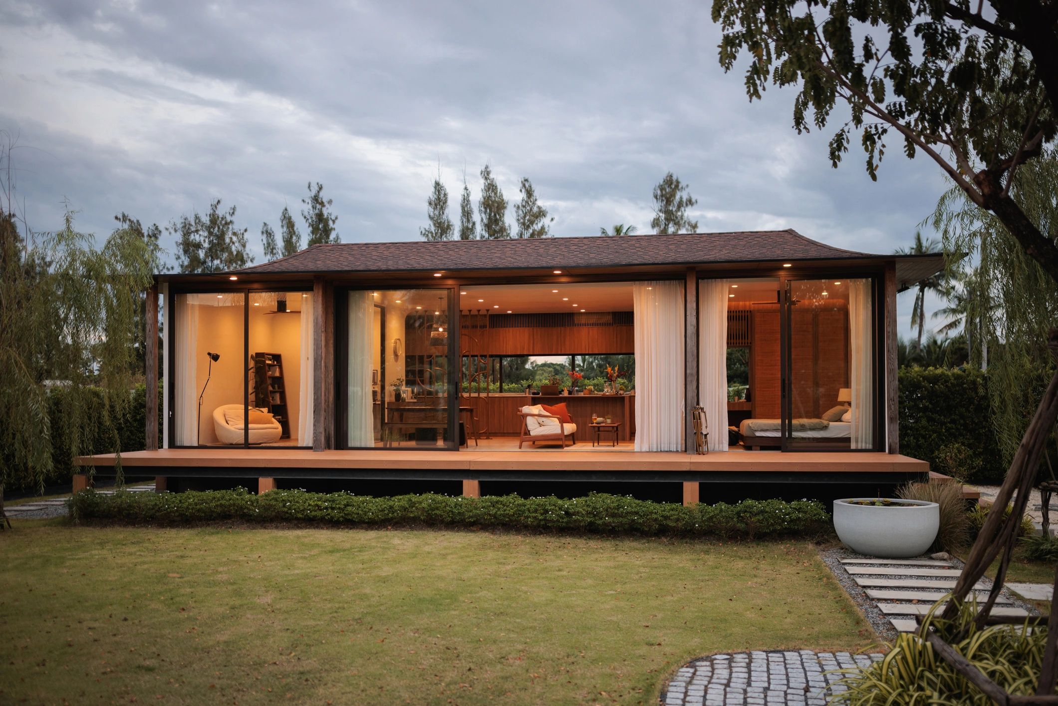 Modern barndominium-style home exterior at dusk