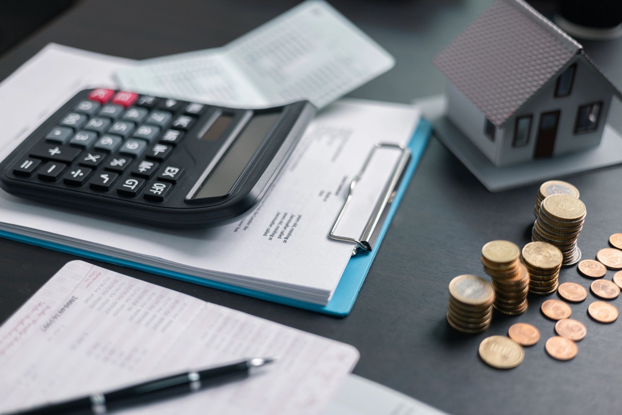 Calculator and financial paperwork on a desk